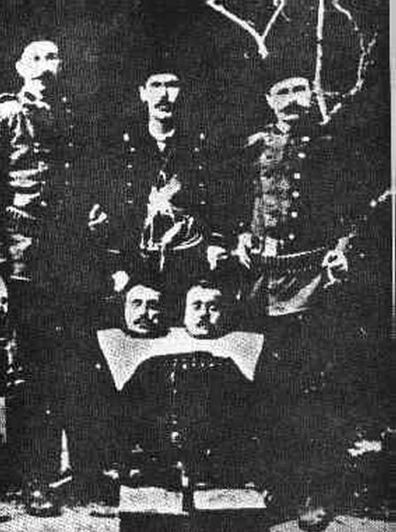 Turkish soldiers posing proudly with heads of their Armenian victims.