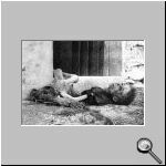 A Christian child lies dead in front of a house.