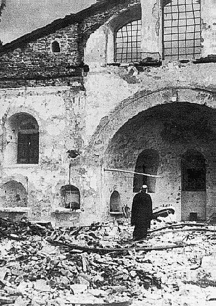 Patriarch Athenagoras I in front of the burnt Church of Saints Constantine and Helene of Ypsomatheion.