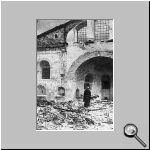 Patriarch Athenagoras I in front of a burnt Church.