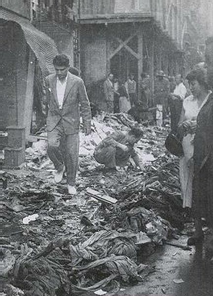 Hellenes look at the destruction of their properties at the Tounel Square.