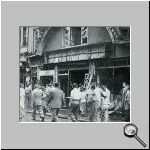 People looking at destroyed Hellenic property.