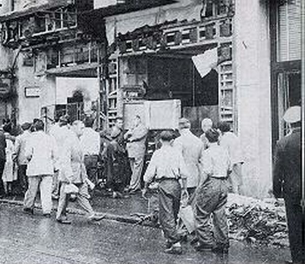 People looking at destroyed Hellenic property.