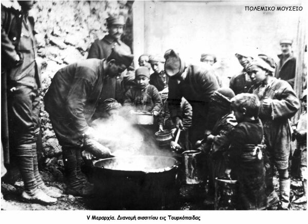 Hellenic soldiers giving food to Turkish children during the war against Turkey.